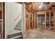Unfinished basement with exposed wood framing, stairs to the upper level, and a concrete foundation at 3272 Creek E Trce, Powder Springs, GA 30127