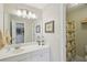 Bathroom featuring a white vanity, a large mirror with lighting, and a shower with a floral curtain at 3272 Creek E Trce, Powder Springs, GA 30127