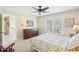 Well-lit bedroom with carpet flooring, a window and a comfy-looking bed with a floral patterned comforter at 3272 Creek E Trce, Powder Springs, GA 30127