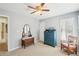 Bright bedroom with carpet flooring, a blue dresser with a chair, a small desk, and natural light from the window at 3272 Creek E Trce, Powder Springs, GA 30127