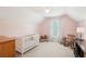 Bright pink Bedroom features a crib, rocking chair, and natural light from the window with floral curtains at 3272 Creek E Trce, Powder Springs, GA 30127