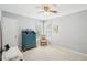 Bright bedroom with carpet flooring, two windows, and a blue dresser with a chair and a small desk at 3272 Creek E Trce, Powder Springs, GA 30127