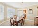 Dining room with a large window offering natural light, adjacent to an open kitchen area at 3272 Creek E Trce, Powder Springs, GA 30127