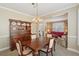 Elegant dining room with a classic wooden table, hutch, and view into the living area at 3272 Creek E Trce, Powder Springs, GA 30127