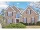 Charming brick home featuring a symmetrical design with a manicured lawn and inviting curb appeal at 3272 Creek E Trce, Powder Springs, GA 30127