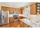 Well-equipped kitchen with stainless steel appliances, granite countertops, and breakfast bar seating at 3272 Creek E Trce, Powder Springs, GA 30127