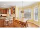 Sunny kitchen nook with bright yellow walls, wooden table, and a view of the window at 3272 Creek E Trce, Powder Springs, GA 30127