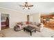 Open-concept living space with access to the kitchen, featuring a comfortable sofa and neutral decor at 3272 Creek E Trce, Powder Springs, GA 30127