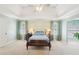 Spacious main bedroom featuring a tray ceiling, and curtains, with natural light streaming through the windows at 3272 Creek E Trce, Powder Springs, GA 30127