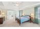 Lovely main bedroom boasts tray ceilings, plush carpet, natural light, and view to main bath at 3272 Creek E Trce, Powder Springs, GA 30127
