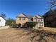 Traditional two-story brick home with well-manicured front yard and red shutters at 5761 Harrier Ln, Atlanta, GA 30349