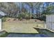 Large backyard featuring lush greenery and a patio area at 5835 Terremont Cir, Norcross, GA 30093
