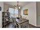 Dining room with a modern chandelier, table and chairs, and decor shelving unit at 5835 Terremont Cir, Norcross, GA 30093