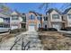 Inviting townhome featuring well-kept landscaping and a private driveway leading to attached garage at 5835 Terremont Cir, Norcross, GA 30093