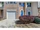 Lovely townhome with a well-kept lawn, driveway, and an attached garage; offers a welcoming appeal at 5835 Terremont Cir, Norcross, GA 30093
