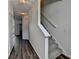 Hallway with modern flooring, neutral paint, and a staircase, creating a seamless transition between levels at 5835 Terremont Cir, Norcross, GA 30093