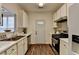 Well-lit kitchen features white cabinets and stainless steel appliances at 5835 Terremont Cir, Norcross, GA 30093
