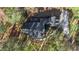 Aerial view of a home with dark roof, surrounded by mature trees, and a long driveway at 121 Rising Star Rd, Fayetteville, GA 30215