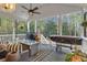 Relaxing back porch with wood flooring, ceiling fan, comfortable seating, and a lush outdoor view at 121 Rising Star Rd, Fayetteville, GA 30215