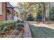 Brick pathway leading to the home and mature landscaping creates a peaceful backyard experience at 121 Rising Star Rd, Fayetteville, GA 30215