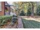 Well-manicured backyard with a brick pathway leading to a cozy covered porch on this charming home at 121 Rising Star Rd, Fayetteville, GA 30215
