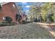 Spacious backyard featuring a brick home with a covered porch and mature trees for privacy at 121 Rising Star Rd, Fayetteville, GA 30215