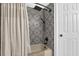 A full bath shows off a tile shower, shower curtain and a modern shower head at 121 Rising Star Rd, Fayetteville, GA 30215