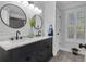 Bright bathroom with double vanity, modern fixtures, and stylish shiplap walls and tiled floors at 121 Rising Star Rd, Fayetteville, GA 30215