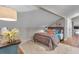 Cozy bedroom featuring a stylish bed, hardwood floors, and unique decor in a sloped ceiling room at 121 Rising Star Rd, Fayetteville, GA 30215