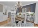 Elegant dining room featuring modern chandelier, wood table, and views to an adjacent kitchen at 121 Rising Star Rd, Fayetteville, GA 30215