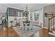 Inviting dining room with chandelier, white table set, bay window with natural light, and hardwood floors at 121 Rising Star Rd, Fayetteville, GA 30215
