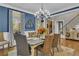Formal dining room with hardwood floors, chandelier, blue walls, and elegant furnishings at 121 Rising Star Rd, Fayetteville, GA 30215