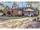 Charming brick home with a covered porch and well-maintained landscaping in a desirable neighborhood at 121 Rising Star Rd, Fayetteville, GA 30215