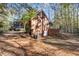 Brick home featuring a covered porch, rear entrance, and a spacious yard with mature trees at 121 Rising Star Rd, Fayetteville, GA 30215