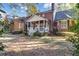 Beautiful brick home showcasing a charming covered porch, manicured landscaping, and curb appeal at 121 Rising Star Rd, Fayetteville, GA 30215