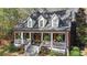 Inviting brick home with a classic front porch, dormer windows, and manicured front yard at 121 Rising Star Rd, Fayetteville, GA 30215