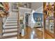 Beautiful foyer with grand staircase, hardwood floors, and elegant decor at 121 Rising Star Rd, Fayetteville, GA 30215