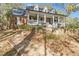Charming two-story brick home with a welcoming front porch and landscaped front yard at 121 Rising Star Rd, Fayetteville, GA 30215