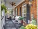 Charming front porch with brick facade, seating, plants, and pendant lighting at 121 Rising Star Rd, Fayetteville, GA 30215