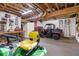 Large unfinished garage used for storage with an ATV, lawn mower, and workbench at 121 Rising Star Rd, Fayetteville, GA 30215