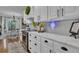 Bright kitchen features white cabinets, stainless steel appliances, and marble countertops at 121 Rising Star Rd, Fayetteville, GA 30215