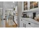 Modern kitchen with white cabinets, marble countertops, and an open view to the dining area at 121 Rising Star Rd, Fayetteville, GA 30215