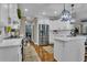 Spacious kitchen with stainless steel appliances, white cabinetry, hardwood floors, and an adjacent dining area at 121 Rising Star Rd, Fayetteville, GA 30215