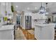 Bright kitchen with white cabinets, stainless steel refrigerator, marble counters, and hardwood floors at 121 Rising Star Rd, Fayetteville, GA 30215