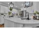 Charming kitchen with marble countertop island, white cabinets, stainless steel appliances, and modern pendant lights at 121 Rising Star Rd, Fayetteville, GA 30215
