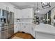 Modern kitchen showcasing stainless steel refrigerator, white cabinets, marble countertops, hardwood floors, and decorative pendant lights at 121 Rising Star Rd, Fayetteville, GA 30215