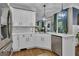 Beautiful kitchen featuring white cabinets, stainless steel appliances, hardwood floors, and stylish pendant lighting fixtures at 121 Rising Star Rd, Fayetteville, GA 30215