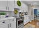 Bright kitchen features white cabinets, stainless steel appliances, and marble countertops at 121 Rising Star Rd, Fayetteville, GA 30215