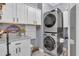 Functional laundry area with stacked washer/dryer and ample cabinet space at 121 Rising Star Rd, Fayetteville, GA 30215