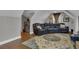 Comfortable living room features hardwood floors, a large oriental rug, and a large black reclining couch at 121 Rising Star Rd, Fayetteville, GA 30215